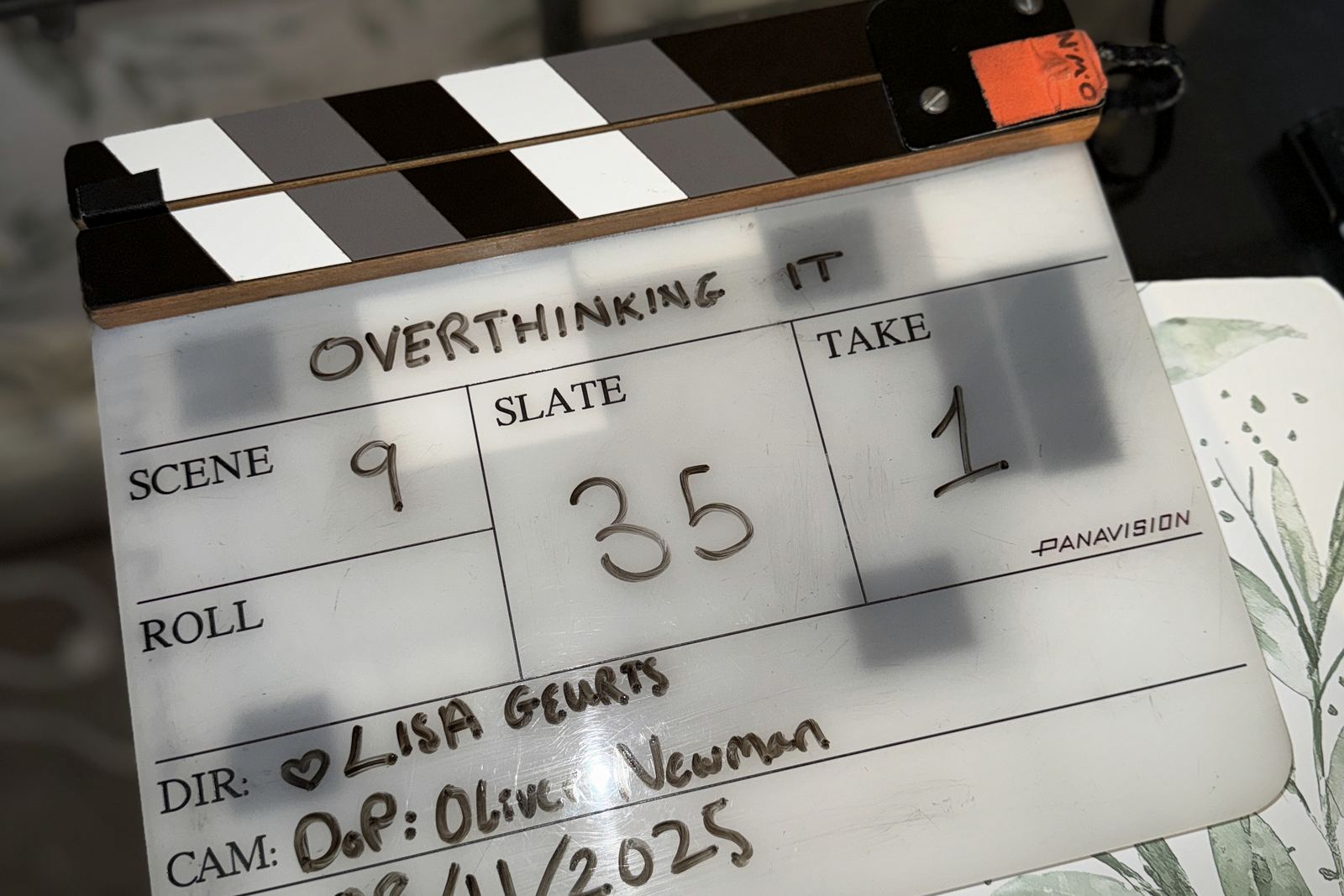 A clapperboard reading Overthinking It, scene nine, slate thirty-five, take one